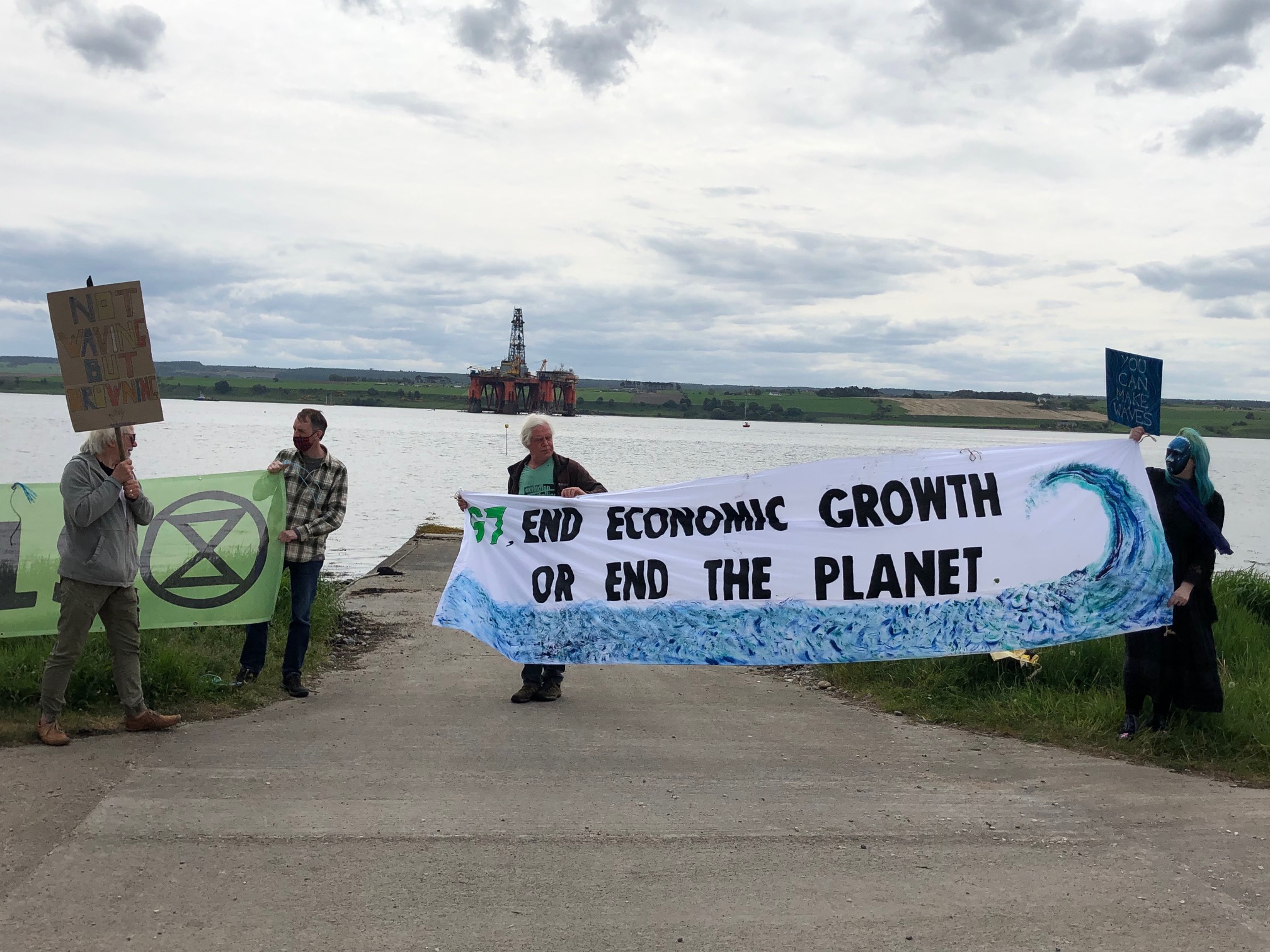 Call for action: Extinction Rebellion Inverness with North Sea oil rigs in the background.