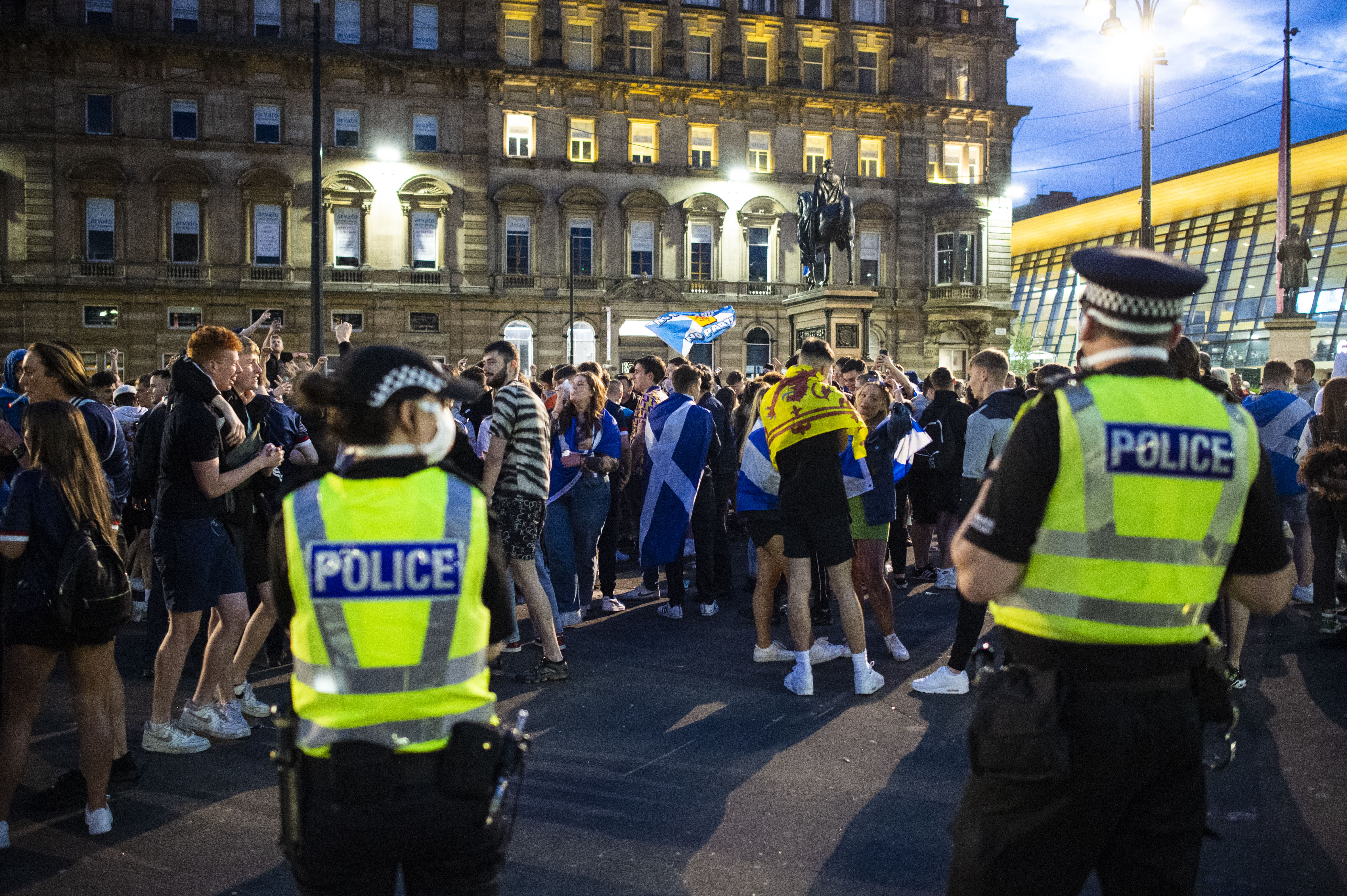 Police watch on as fans arrive at George Square.