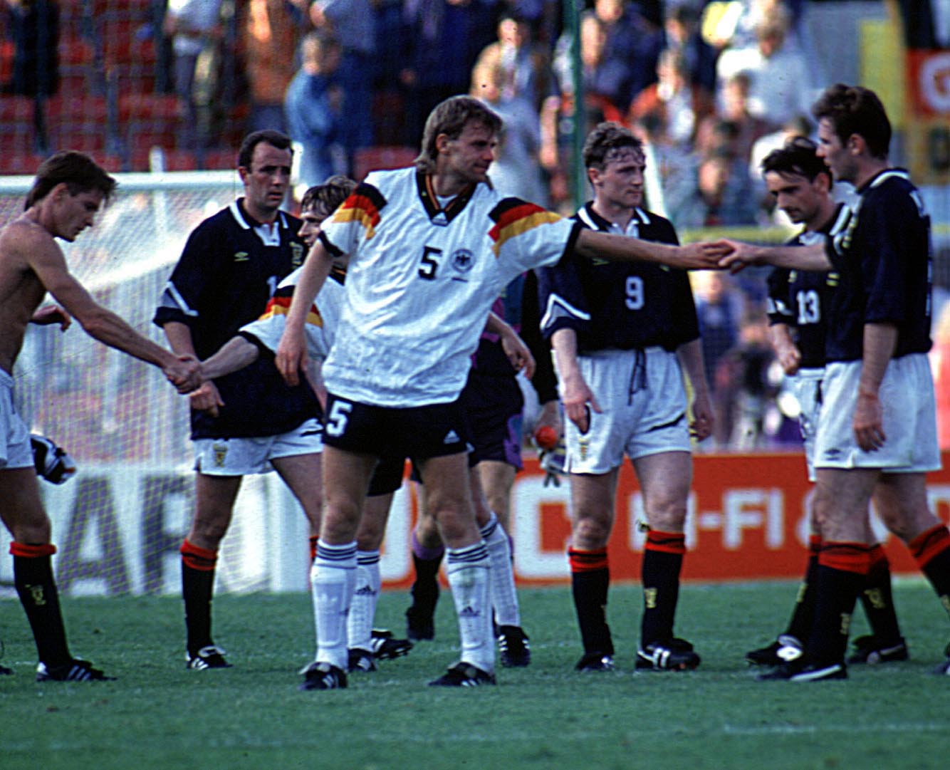 Germany's Manfred Binz shakes hands with Brian McClair.