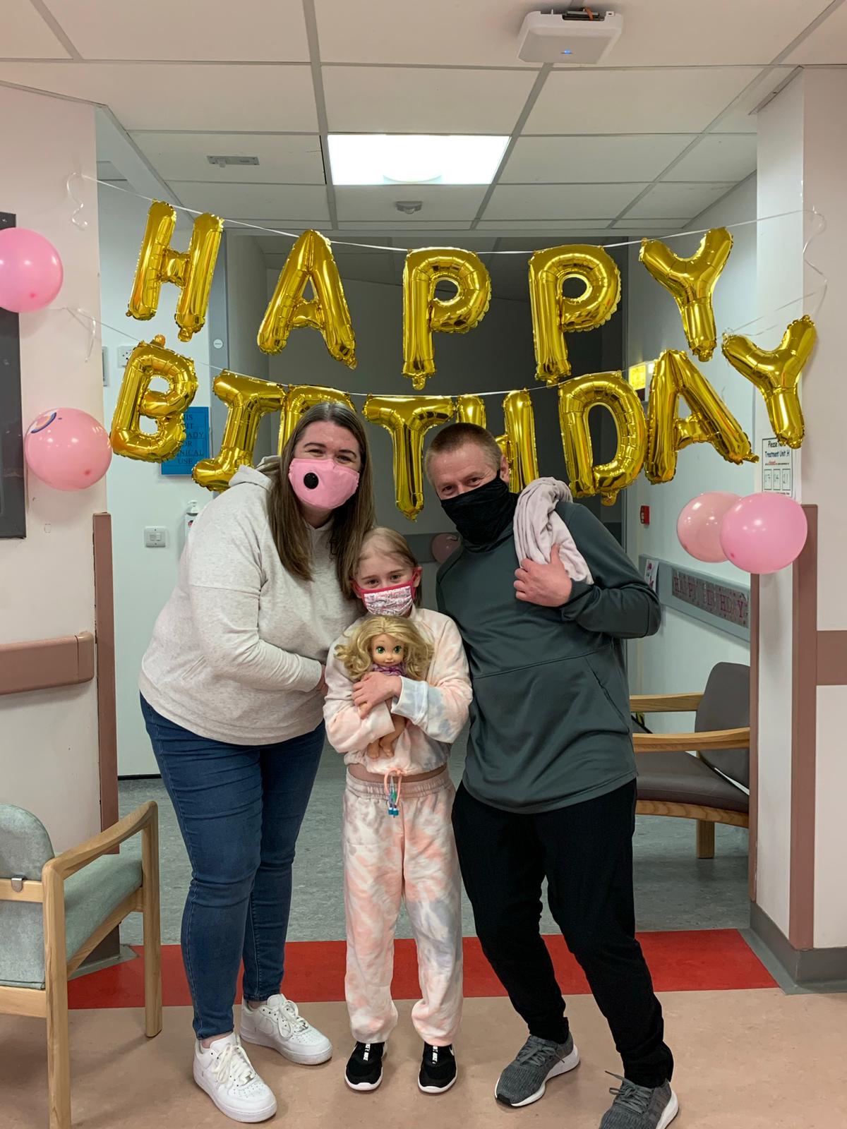 Katie with her parents on her birthday.