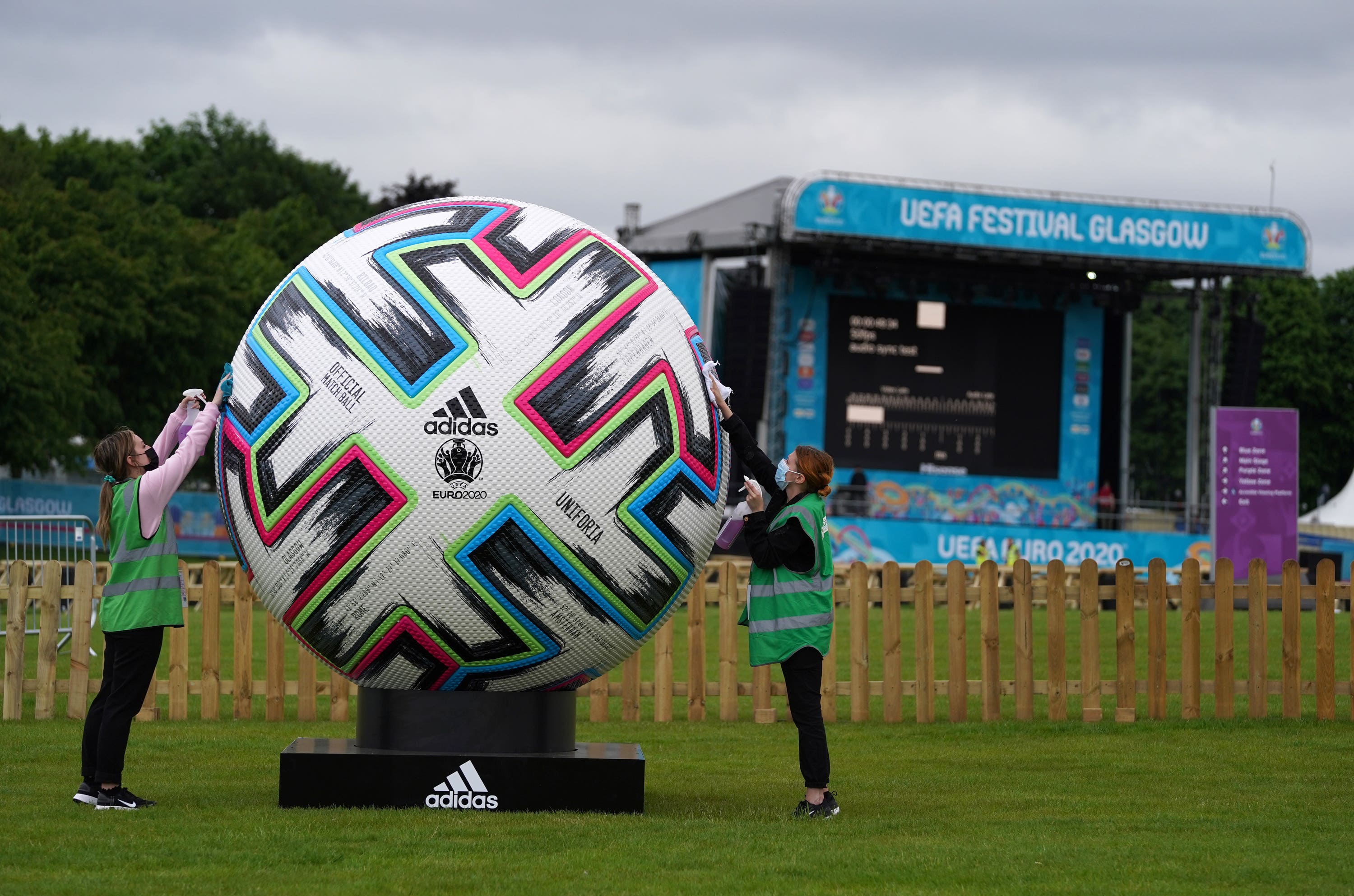 Workers clean a giant ball at the Euro 2020 fan zone in Glasgow Green (Andrew Milligan/PA)