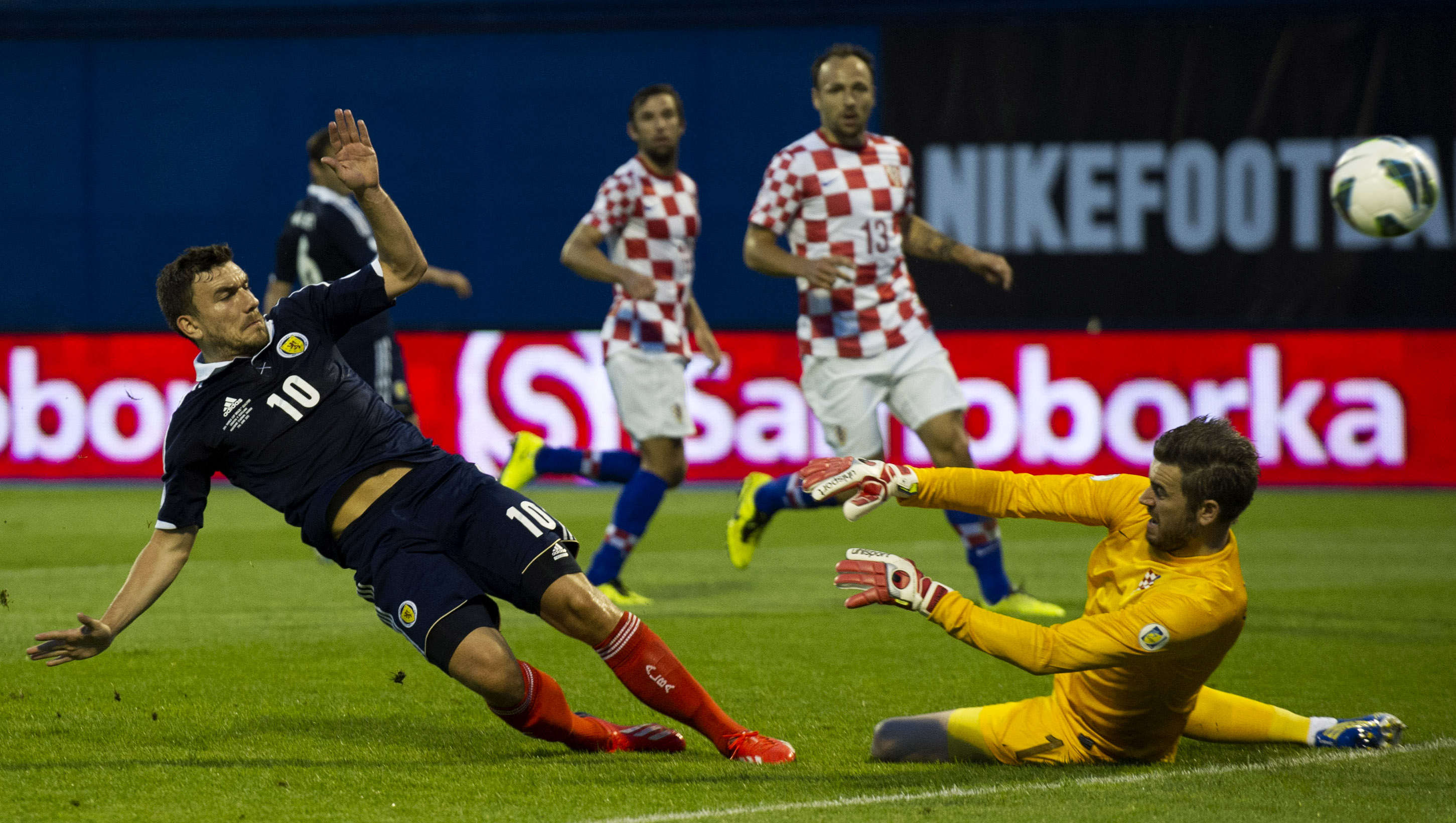 Robert Snodgrass slides in to give Scotland the lead.