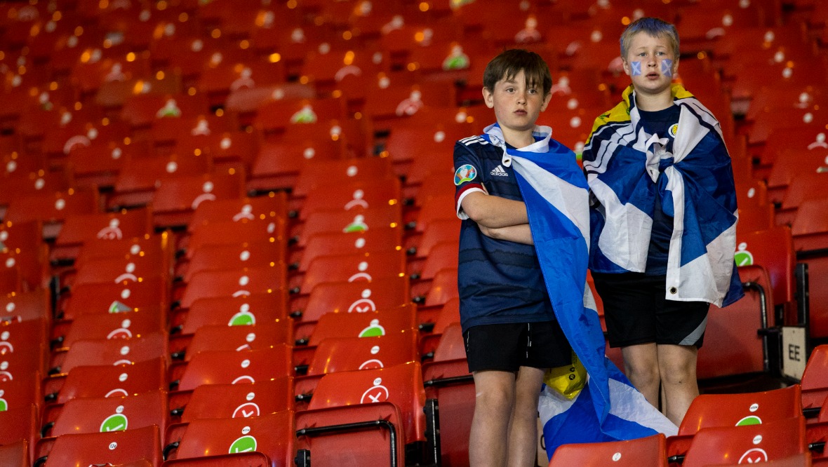Young boys watch on as Scotland crash out of the tournament. 