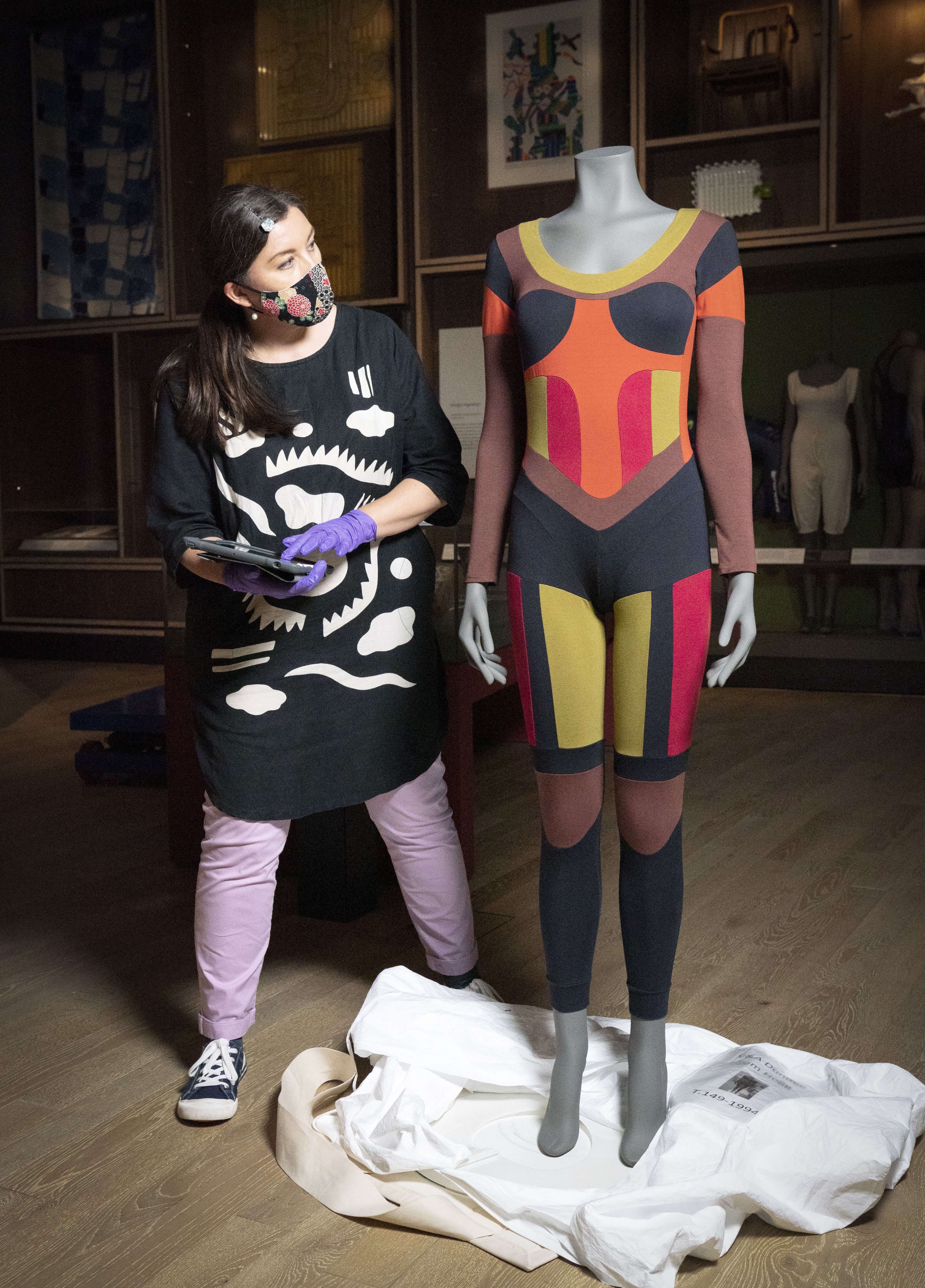 Lead textile conservator Elizabeth Anne Haldane carries out a condition check on a multicoloured bodysuit by designer Pam Hogg before going on display in the Scottish Design Galleries at the V&A in Dundee. 