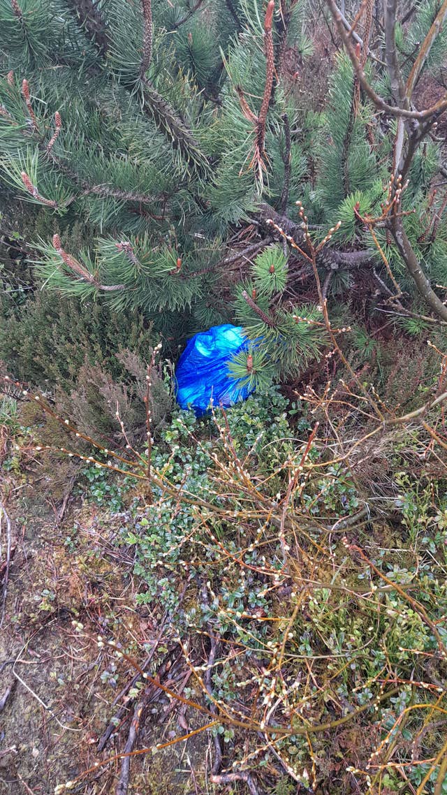 A bag of rubbish was found hidden in bushes (Cairngorms Mountain Rangers/PA)