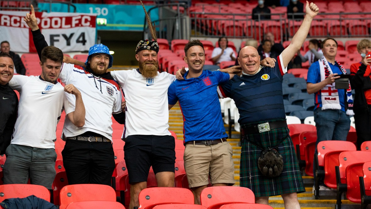 Auld Enemy: England and Scotland fans bond at Wembley. 