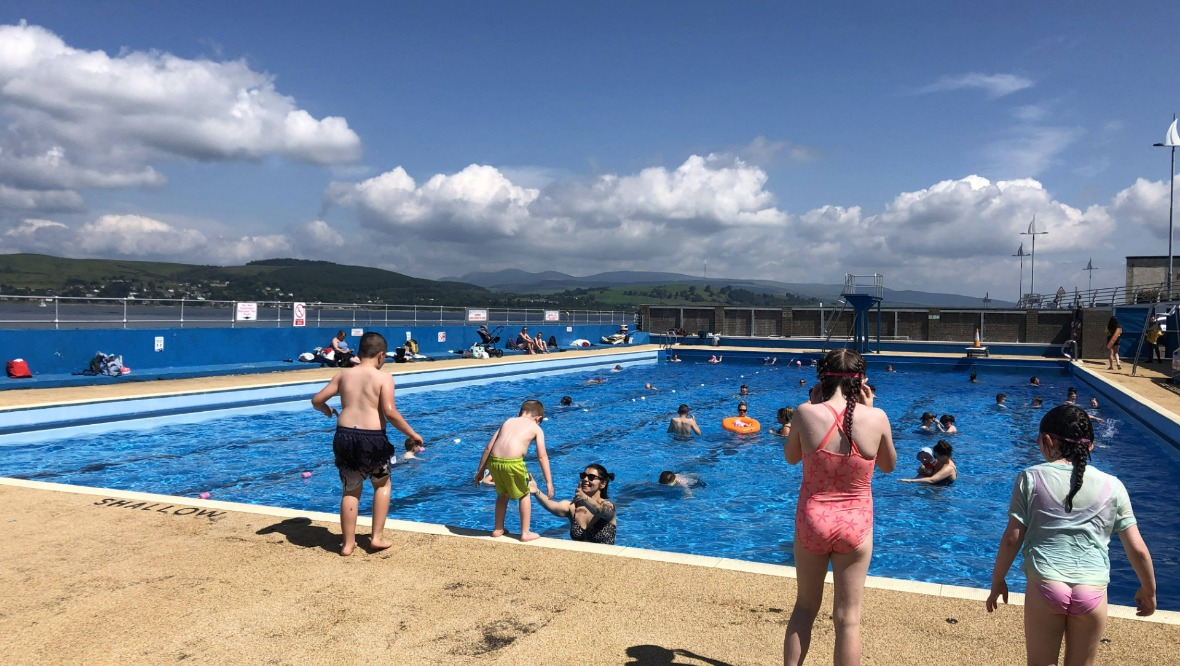 Swimming: Families enjoying the sunshine.