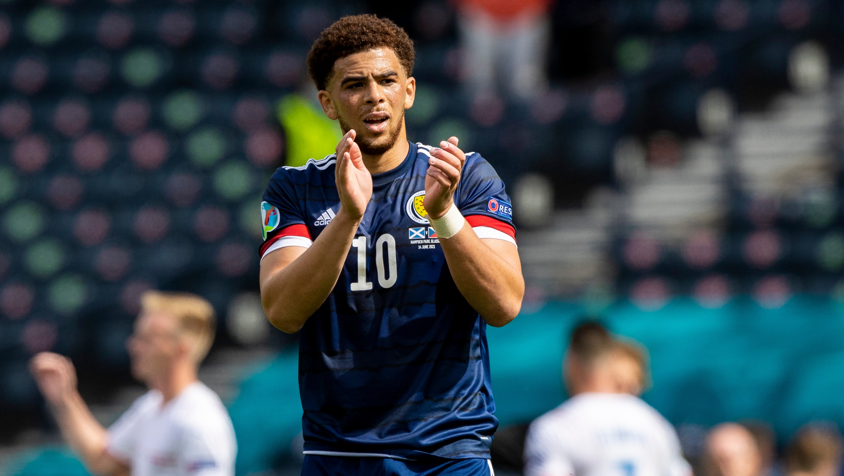 Che Adams applauds the Tartan Army at full-time.