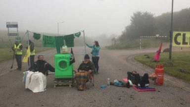 Climate activists block power station with washing machine