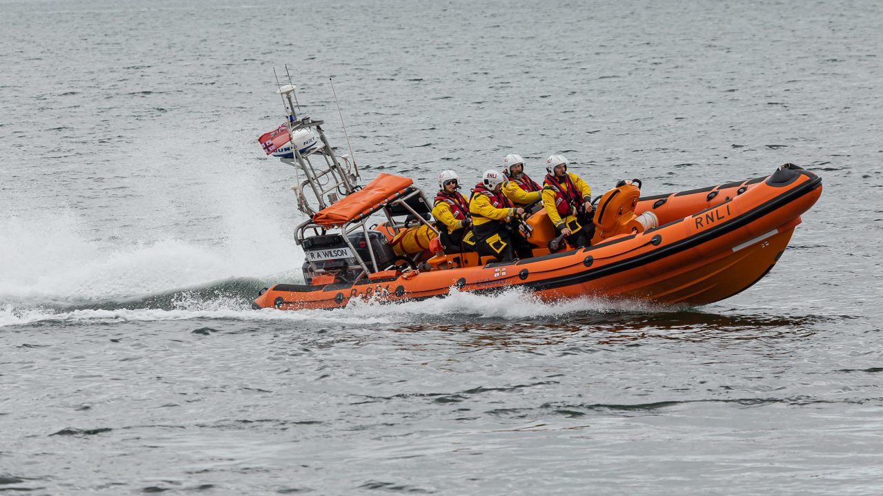 Mother and children rescued from sea after dinghy capsizes