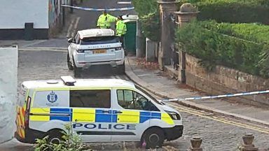 Street locked down after man found seriously injured