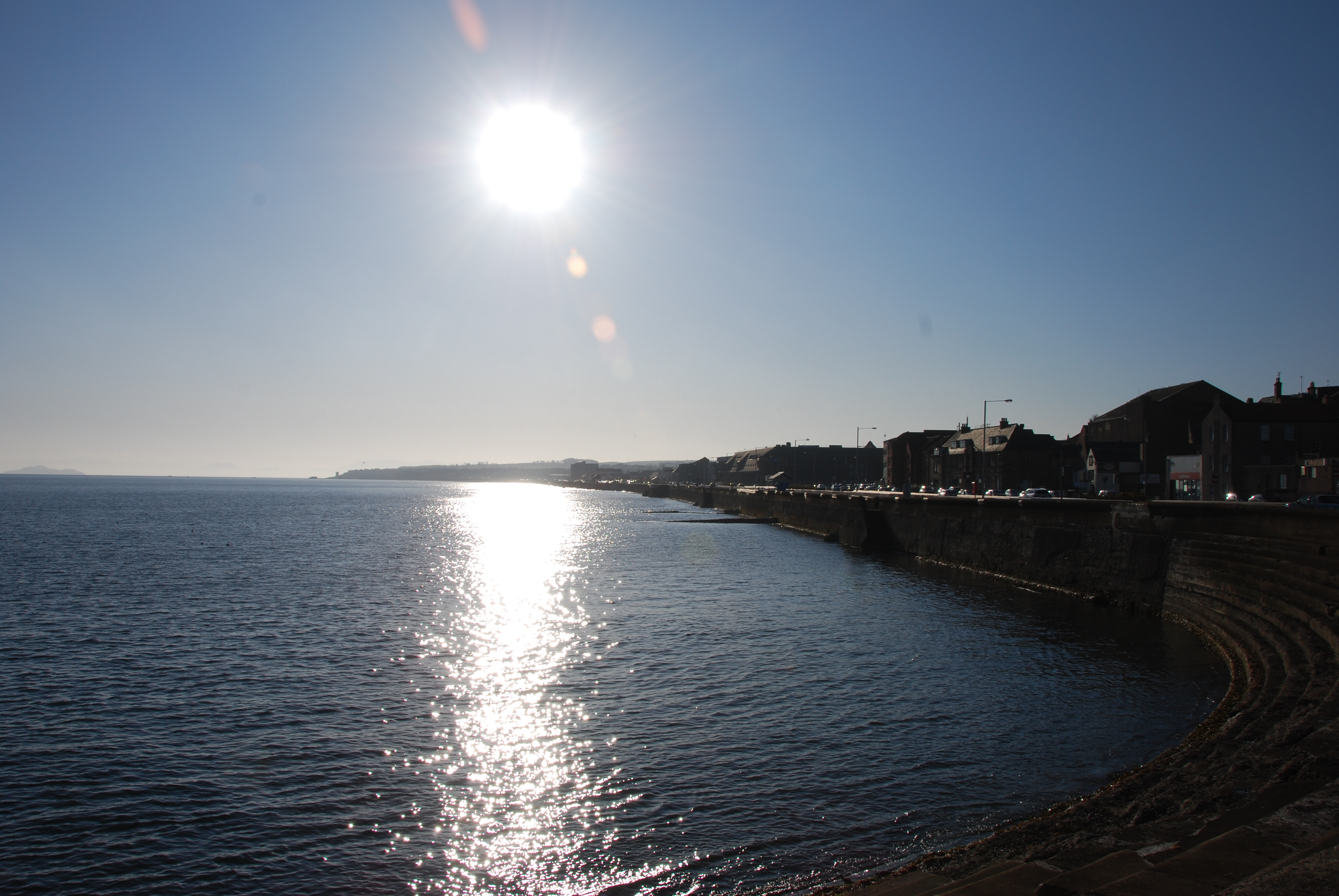 The sun shines over the waterfront at Kirkcaldy during high tide.
