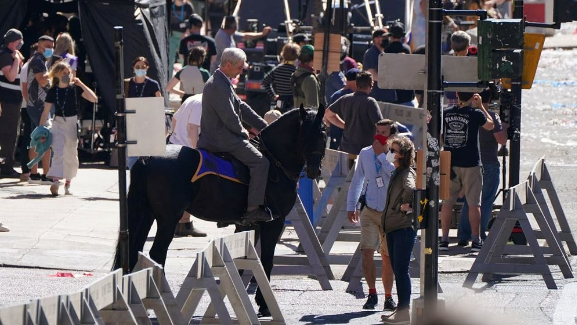 Camera: The Harrison Ford body-double on a horse.