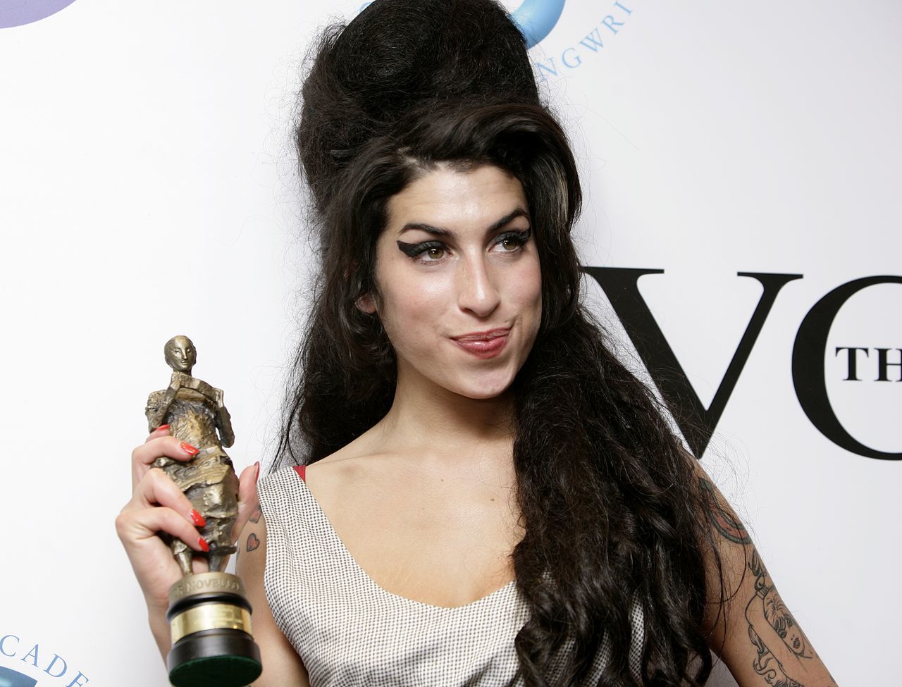 Winehouse after winning the Best Contemporary song award for her song 'Rehab' at the Ivor Novello Awards. (PA Media/Yui Mok)