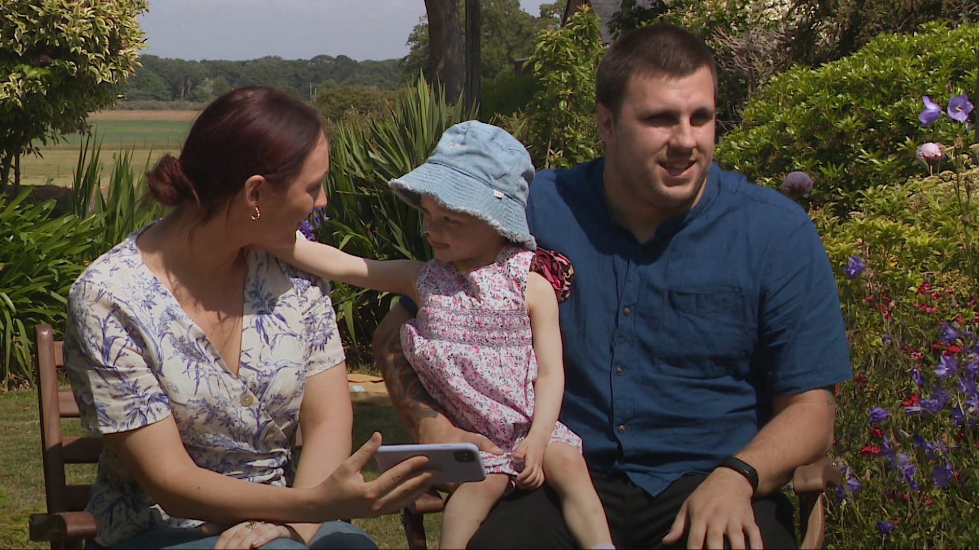 Flora with her mum and dad.