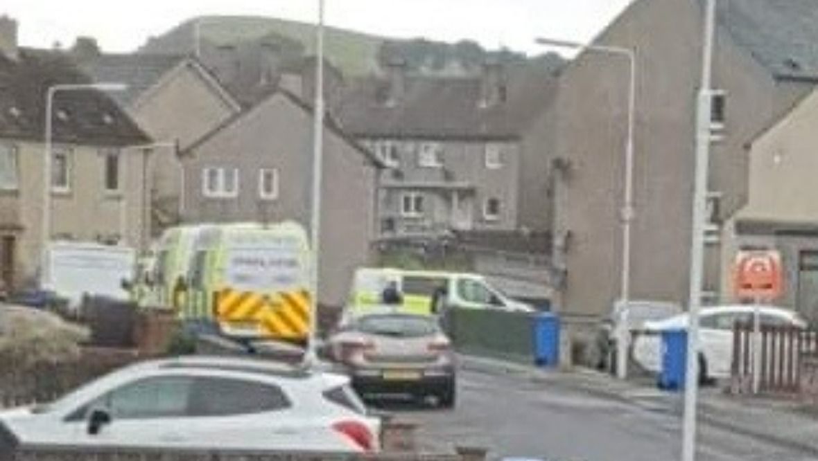Riot police in flat raid as area taped off amid disturbance