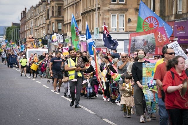 People from the Glasgow Southside community take part in the Govanhill Carnival (Jane Barlow/PA)
