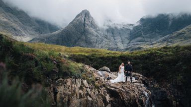 Couple surrounded by tourists during Fairy Pools wedding
