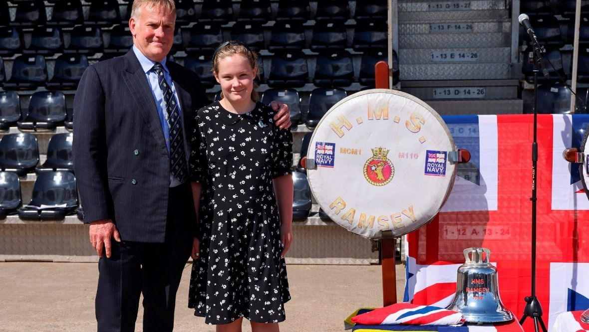 Family: Steve Brown and his daughter, Bella, with HMS Ramsey's bell.