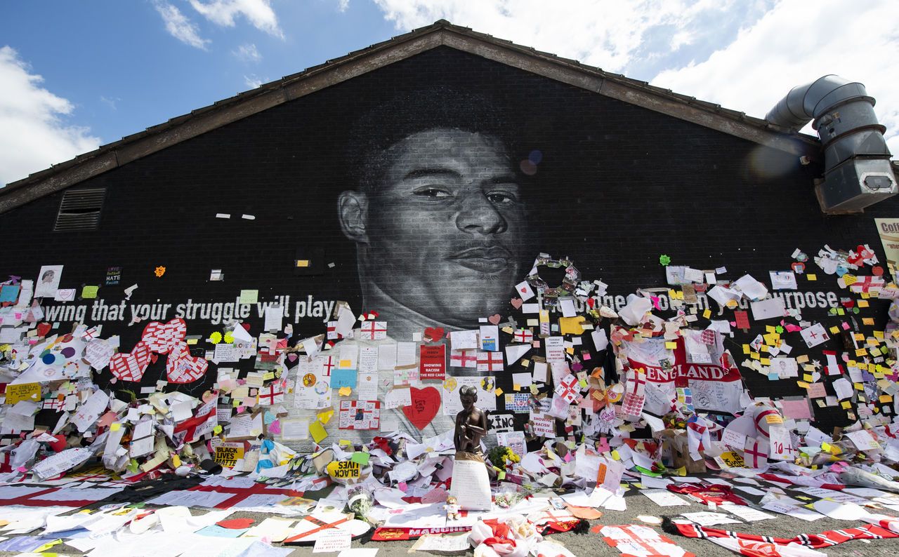 Tributes are lain outside of a mural of Manchester United and England striker Marcus Rashford after it was defaced.