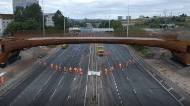 Main span of new cycle and pedestrian bridge over M8 installed