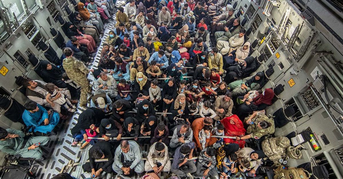 Afghans on board an RAF plane as they fled their homeland this time last year.