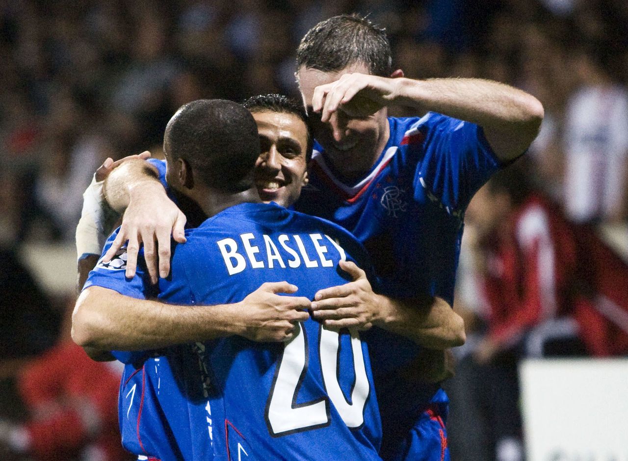 DeMarcus Beasley, Brahim Hemdani and David Weir celebrate a famous win.