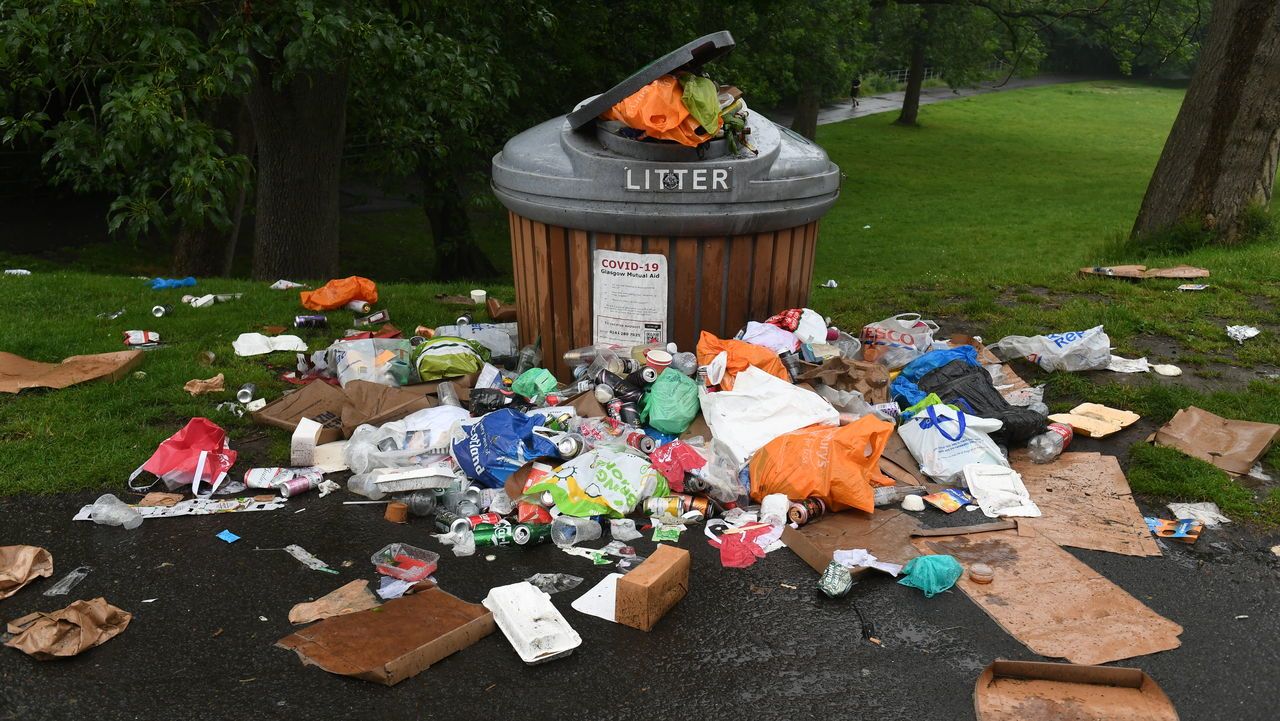 Litter piles up around an overflowing rubbish bin in Glasgow's Kelvingrove Park.
