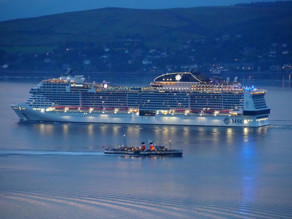 Waverley paddler steamer dwarfed by cruise ship on the Clyde