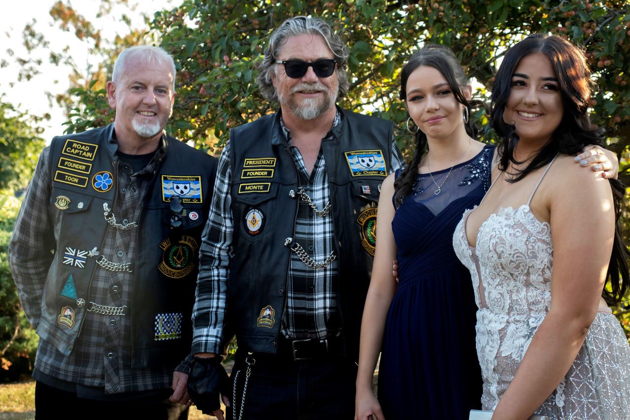 Felicity with friend Emily and some of the bikers who helped escort her to prom. 