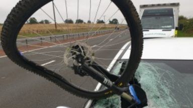 Woman taken to hospital after bicycle strikes car windscreen on motorway