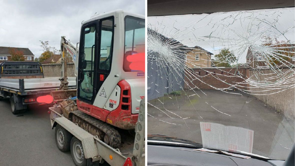 Truck with smashed windscreen and wrecked tyre stopped towing digger