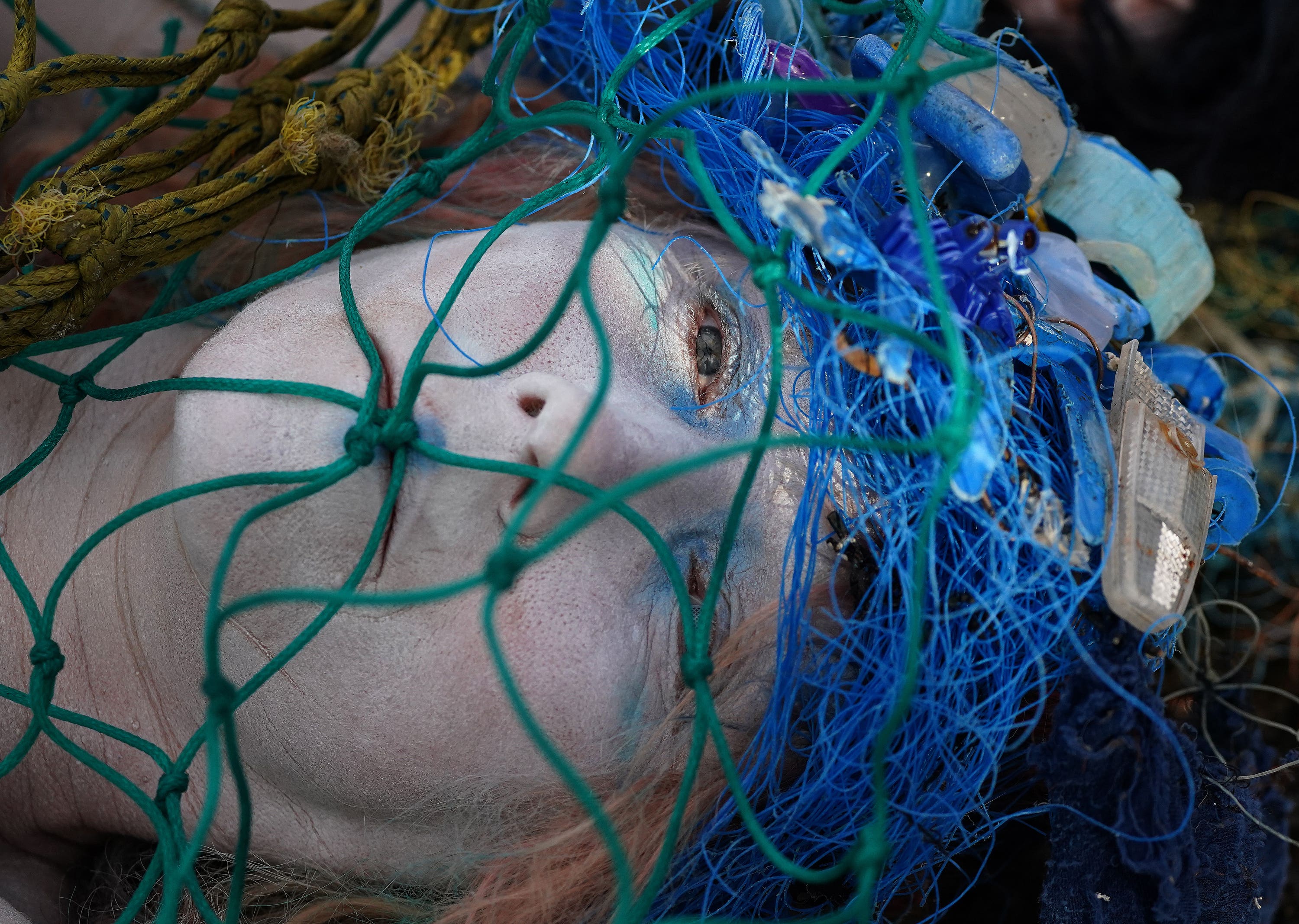 Earlier, activists from Ocean Rebellion staged a ‘dead merpeoples’ stunt opposite the COP26 venue, with activists lying still entangled in netting and litter.