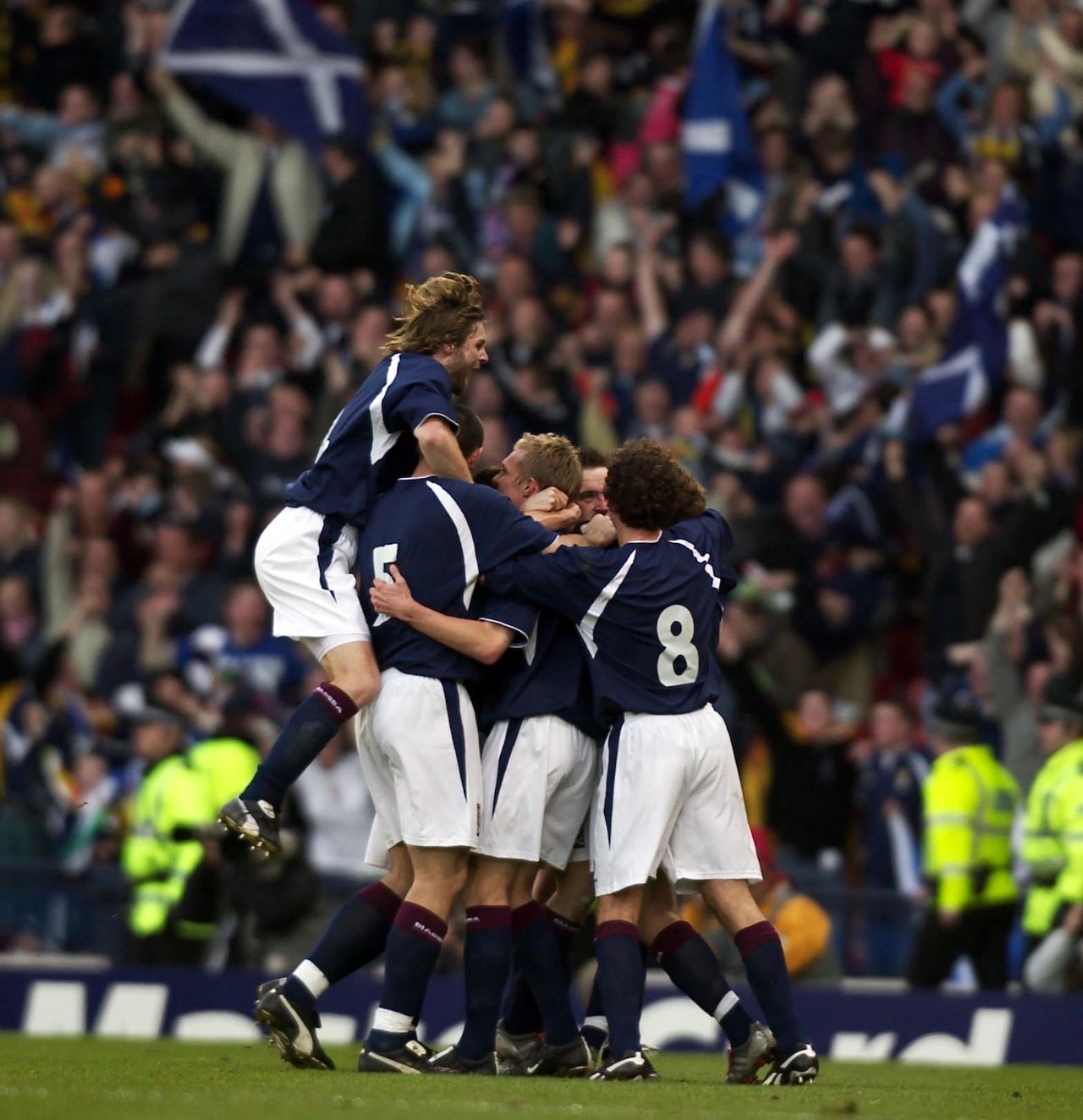 Steven Pressley leaps highest as the Scotland team piles on James McFadden to celebrate his strike against Holland. It was the only goal of the game in a famous win, but the joy turned to misery as the Scots went down 6-0 in the second leg in Amsterdam.