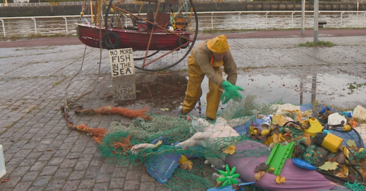 The activists from campaign group Ocean Rebellion staged the theatrical protest on the banks of the Clyde opposite from where the UN climate summit is being held.