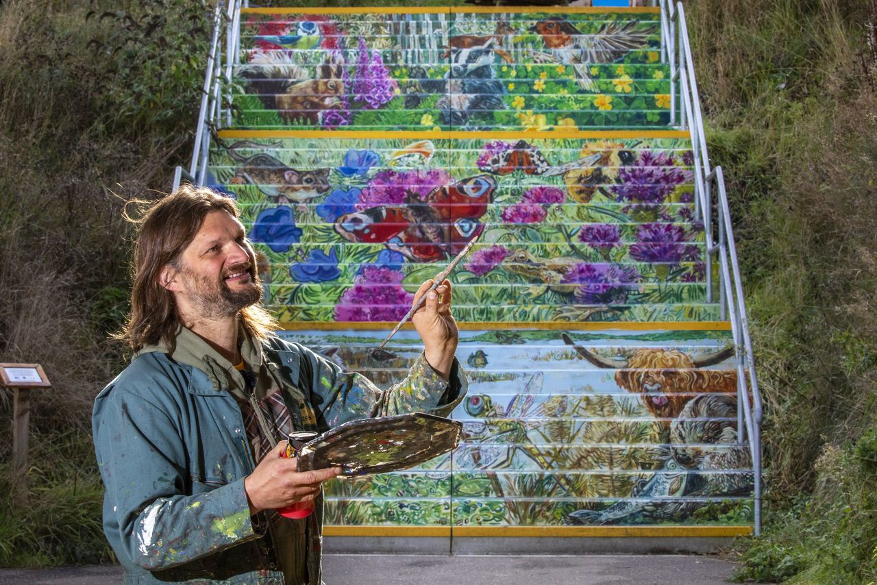 Artist Chris Rutterford on steps at RSPB Loch Leven. SWNS