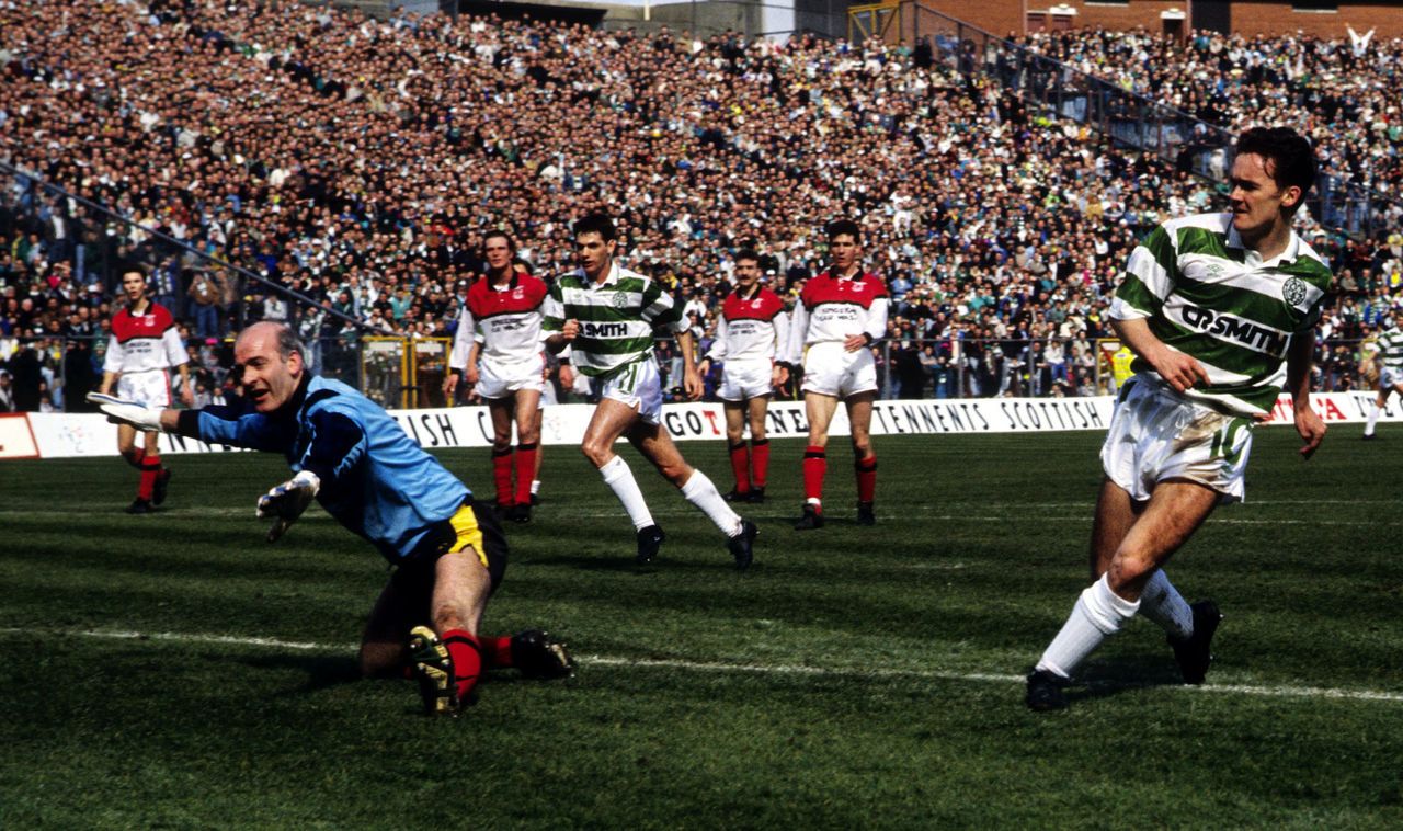 Andy Walker gets the better of Jim Gallagher to open the scoring for Celtic.