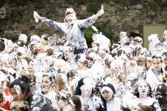 Students let hair down for traditional Raisin Monday foam fight