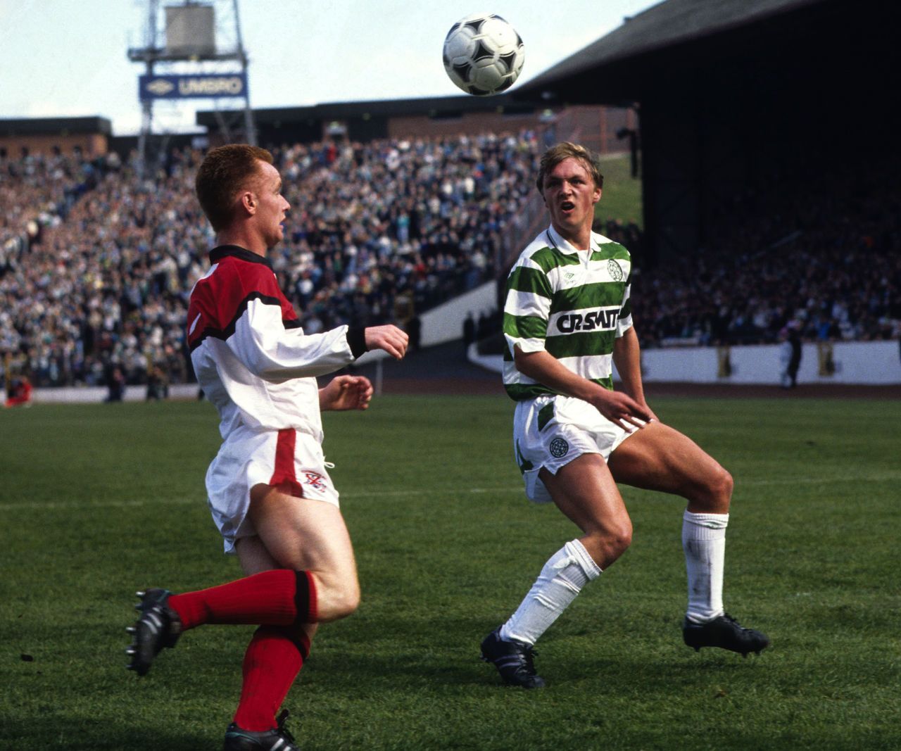 Clydebank's Paul Harvey and Celtic midfielder Steve Fulton battle for possession.