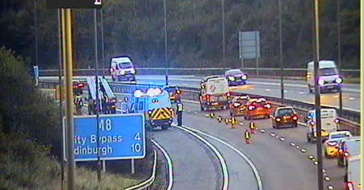 M8 partially blocked after shedload spills on carriageway