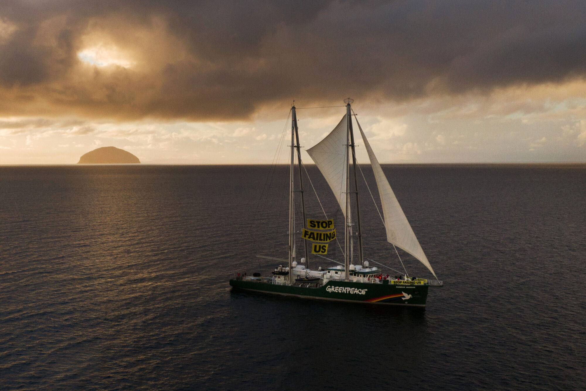 Rainbow Warrior passes Ailsa Craig on its way to defy authorities by sailing up the Clyde.