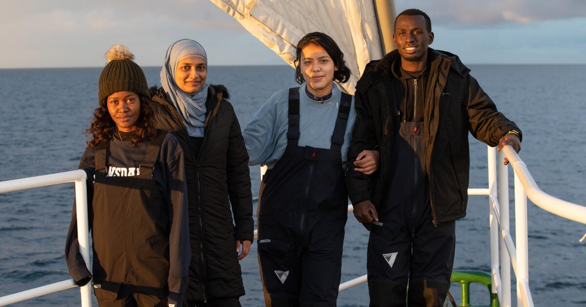 Fridays for Future youth climate activists Jakapita Faith Kandanga, 24, from Namibia, left, Farzana Faruk, 22, from Bangladesh, second left, Maria Reyes, 19, from Mexico, second from right, and Edwin Moses Namakanga, 27, from Uganda pose for a photograph aboard the Greenpeace ship Rainbow Warrior.