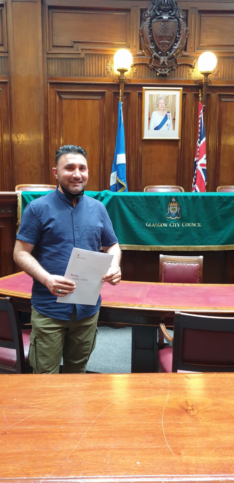 Jan Mohammad Ahmadzai receiving his Glasgow City Council taxi drivers' licence.