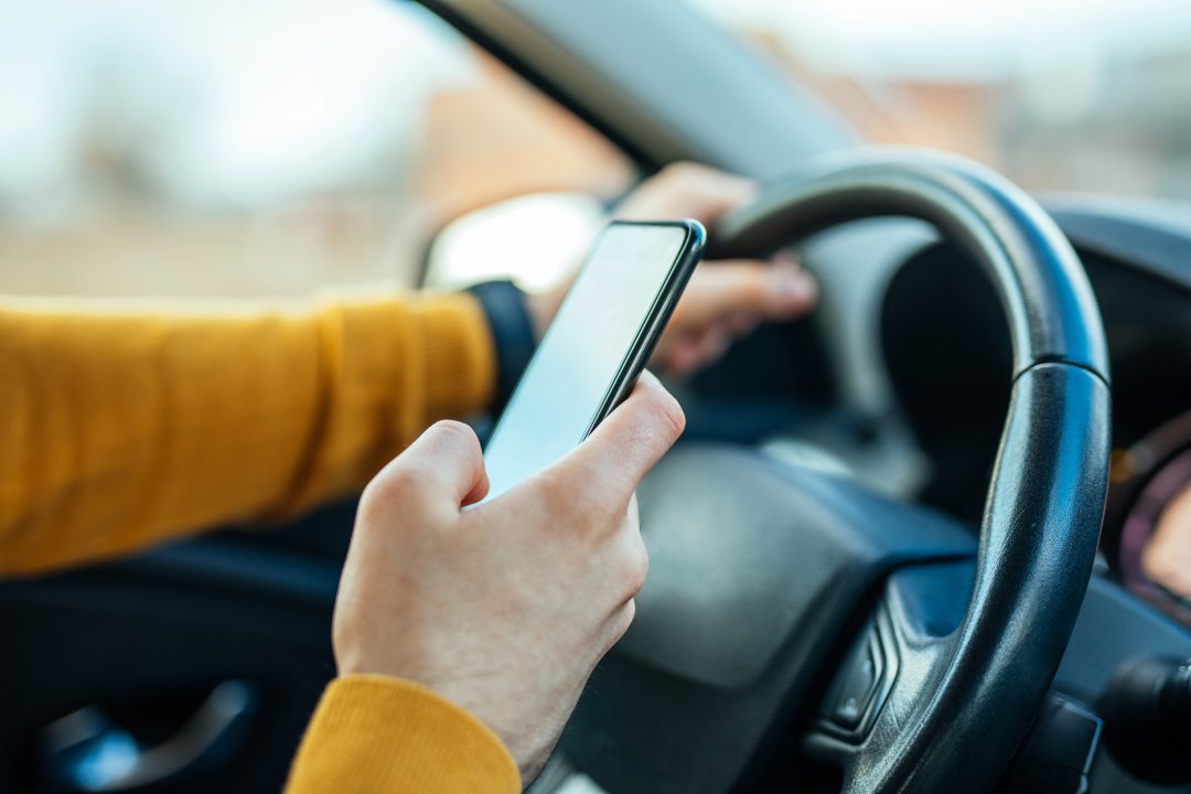 Drivers to be banned from scrolling through playlists on phones