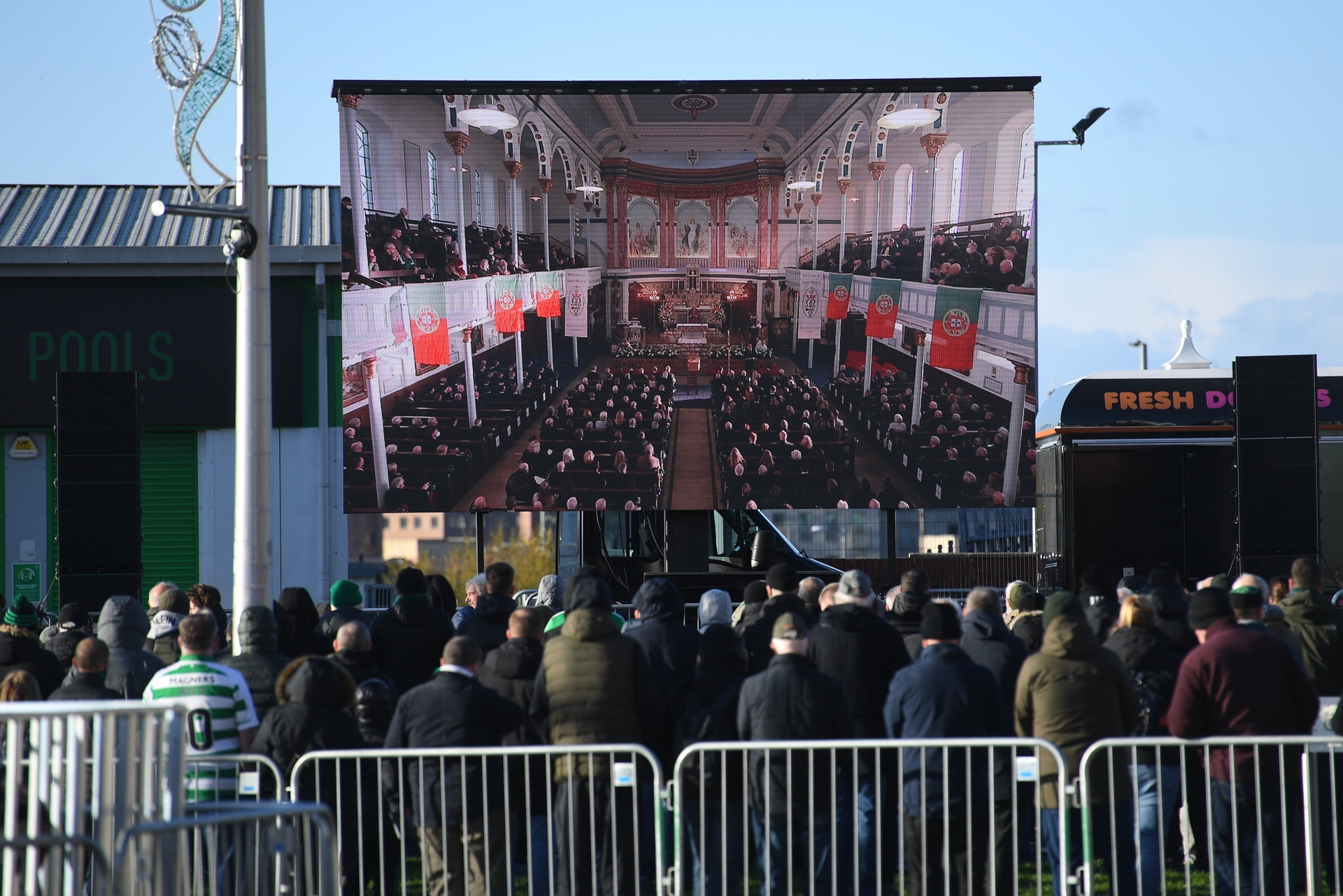 Big screen: Fans gather at Celtic Park for Bertie Auld's funeral service.