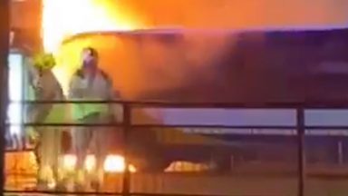 Passengers evacuated after bus bursts into flames on busy road