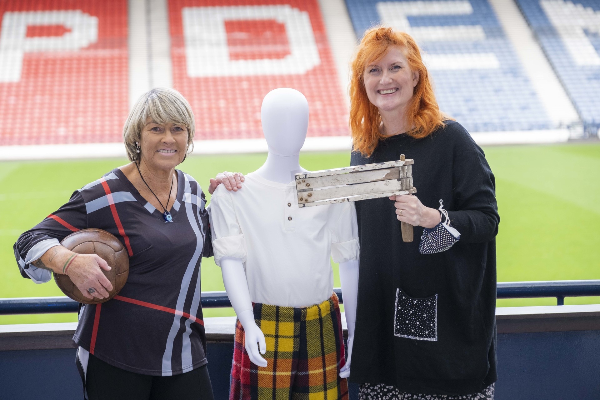 Reader (right) at the launch of a women's football exhibition at Hampden.