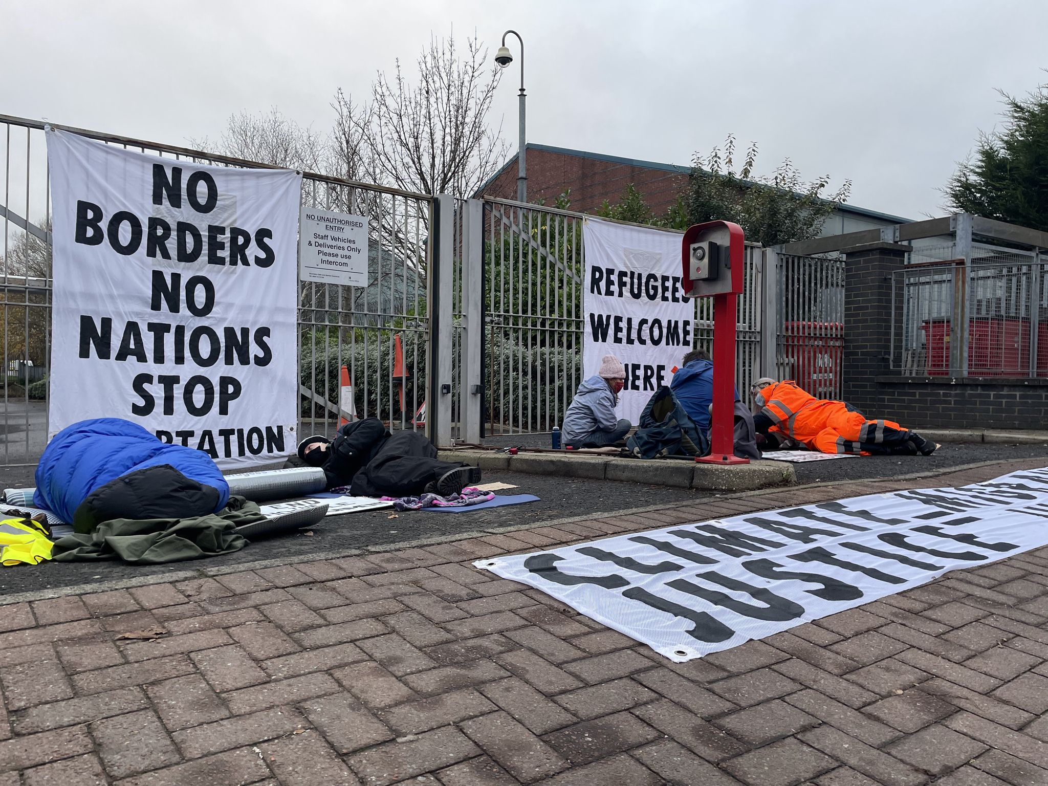 Protestors chained themselves to the fence around 7am on Monday. 