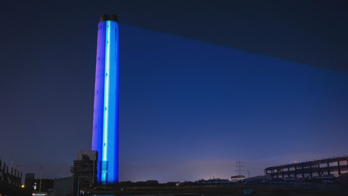 Global warming stripes: The chimney was lit up prior to its demolition.