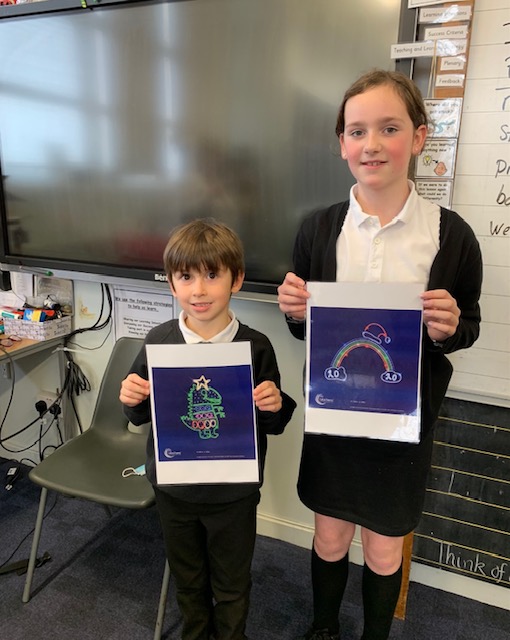 Primary two pupil Arlo Nicol and primary seven pupil Lois Murray with their winning designs.